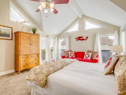 een slaapkamer met een groot bed en een rode bank bij Almost Heaven in Tybee Island