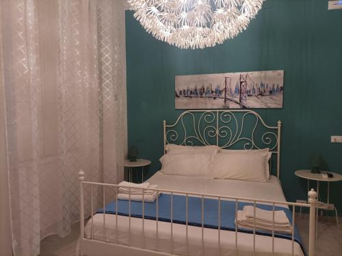 a bedroom with a bed with a chandelier at B&B Il Siciliano in Syracuse