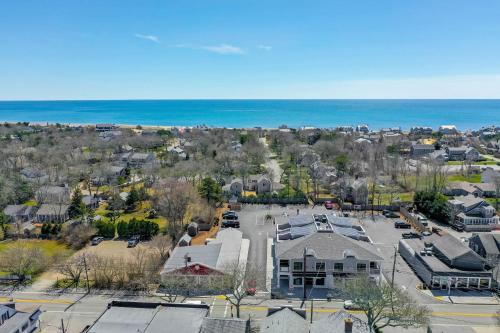 an aerial view of a parking lot and the ocean at 557 Route 28, Unit 202, Harwich Port Cape Cod - -Dolce Vita in Harwich Port