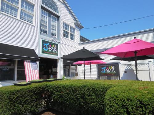 a restaurant with pink umbrellas in front of a building at 557 Route 28, Unit 202, Harwich Port Cape Cod - -Dolce Vita in Harwich Port