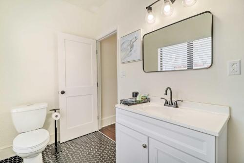 a bathroom with a white sink and a toilet at Stunning Jacksonville Getaway with Backyard! in Jacksonville