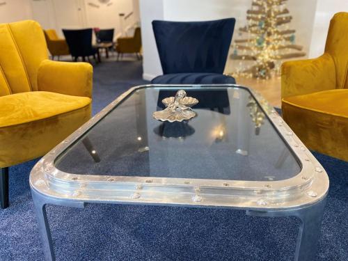 a glass table with a figurine on top of it at Rooms At Babbacombe in Torquay