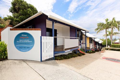 
a large white building with a sign on the side of it at Clubyamba Beach Holiday Accommodation - Adults Only in Yamba
