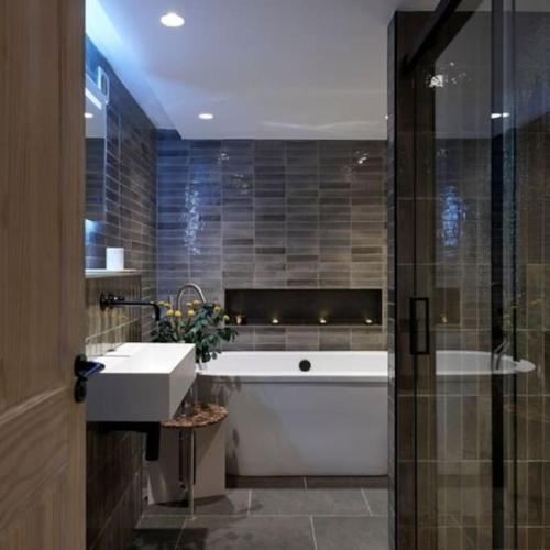 a bathroom with a sink and a bath tub at Ainster House in Fife
