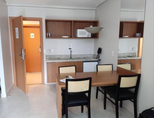 a kitchen with a dining room table and chairs at Salinas Exclusive Resort in Salinópolis