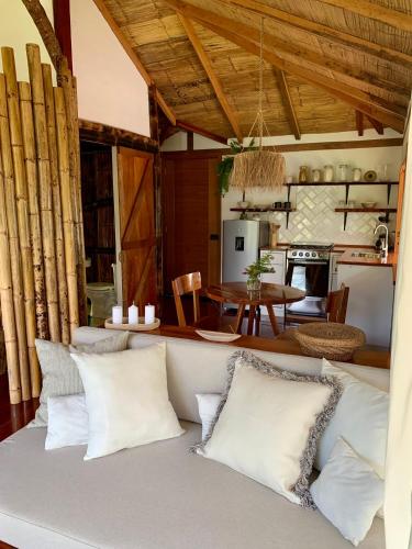 a living room with a couch with pillows at Wild Wasi Lodge - Adventures - Guided Tours in Puyo