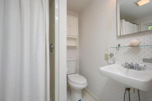 a bathroom with a white toilet and a sink at 6 Brooks Lane Harwich Port Cape Cod- - Brooks Lane Beach House in Harwich Port