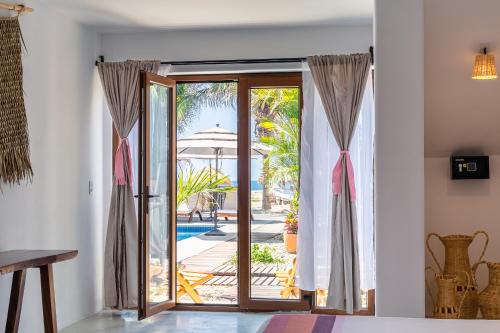 a room with a door open to a patio at Casa Kuaa in Brisas de Zicatela