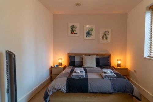 a bedroom with a bed with two towels on it at Hawkesmoor House in London