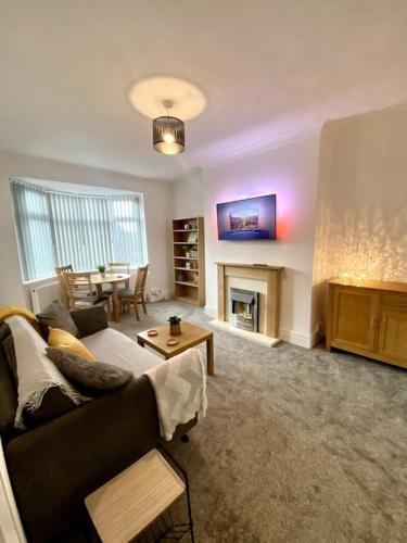 a living room with a couch and a fireplace at Private Northumberland Apartment - FREE PARKING in Cowpen