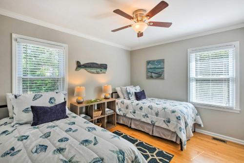 a bedroom with two beds and a ceiling fan at Modern Southern Comforts Home Near Charleston in Charleston