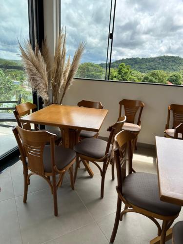 a table and chairs in a room with a large window at HOTEL TERRA NATIVA in Alter do Chao
