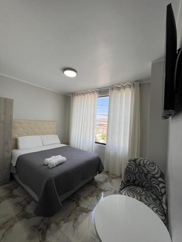 a bedroom with a bed and a window at Makai - Nayarak Paracas in Paracas