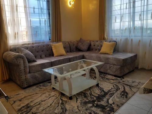 a living room with a couch and a coffee table at Cozy Apartment - Nyali Mombasa in Mombasa