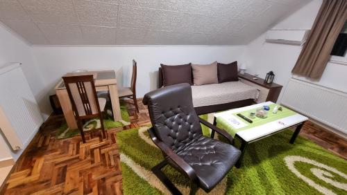a living room with a chair and a table at Fortress apartments Niš in Niš