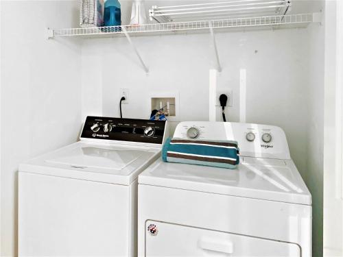 a white washer and dryer in a laundry room at 31 Pine Road West Dennis Cape Cod - - Shark Lookout in West Dennis