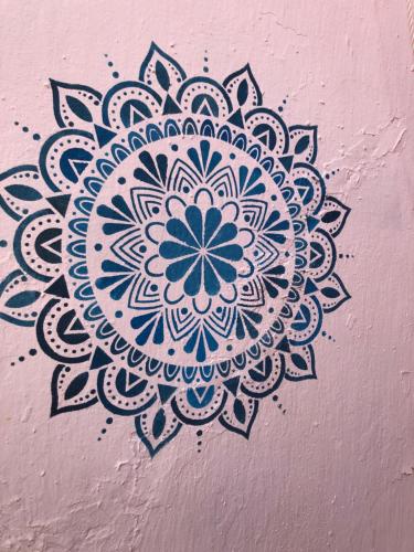 a blue and white mandala painted on a wall at Buddha Bee - 18 to 35 years old only in Lagos