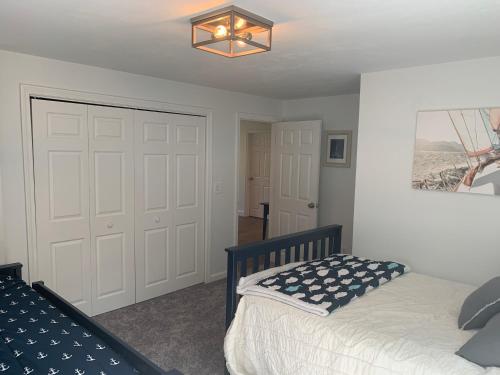 a bedroom with a bed and a chandelier at 21 Moon Compass Lane Sandwich - - Moon Compass Escape in Sandwich