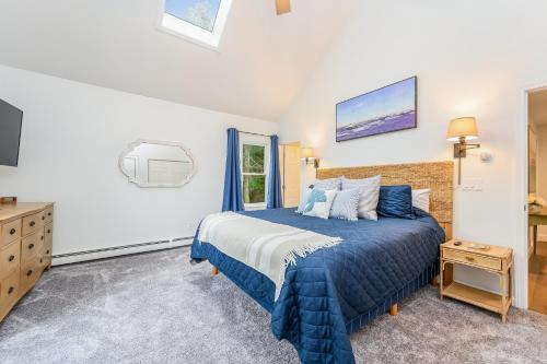 a bedroom with a blue bed and a window at 21 Moon Compass Lane Sandwich - - Moon Compass Escape in Sandwich