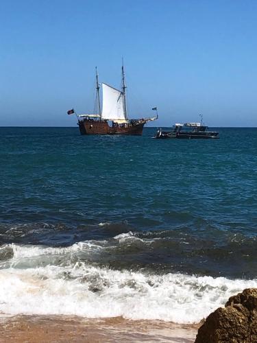 two boats floating in the ocean next to a beach at Buddha Bee - 18 to 35 years old only in Lagos