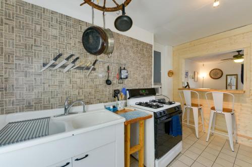 a kitchen with a sink and a stove at Wildwood Apartment - Porch and Enclosed Sunroom! in Wildwood