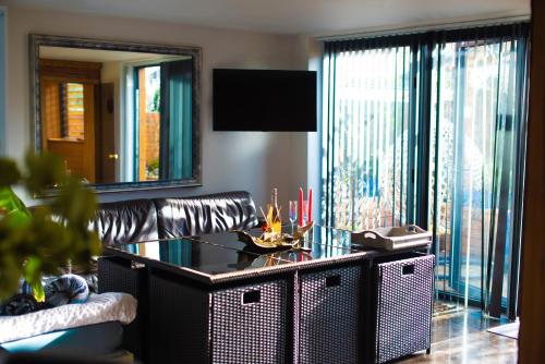 a living room with a couch and a table at 1 Bedroom Guest House with Sauna and Steam Room in Kent