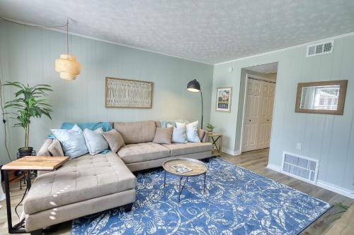 a living room with a couch and a blue rug at Coastal Cottage 1/2 mile from Covington Square in Covington