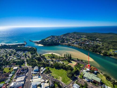 an aerial view of a city and a beach at SunnySide Up Unit 1, 3 McDonalds Place Evans Head in Evans Head