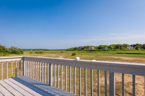 a deck with a view of a golf course at 168 #8 North Shore Boulevard Tidal View #8 East Sandwich - Cape in East Sandwich