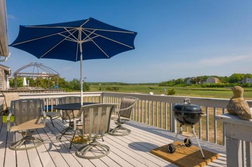 a patio with a grill and a table with an umbrella at 168 #8 North Shore Boulevard Tidal View #8 East Sandwich - Cape in East Sandwich