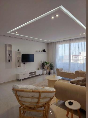 a living room with a couch and a tv at Appartement Residence Essayedi Sousse in Port El Kantaoui