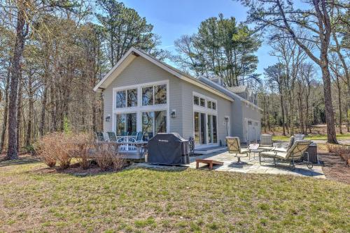 a small house with a patio and a yard at Sun Serenity at A Wave From It All in Pocasset