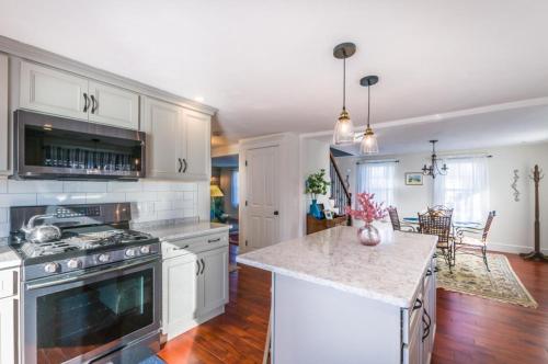 a kitchen with white cabinets and a counter top at 12 Feake Avenue Sandwich - Cape Cod in Sandwich