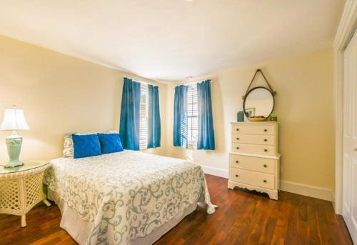 a bedroom with a bed and a dresser and a mirror at 12 Feake Avenue Sandwich - Cape Cod in Sandwich