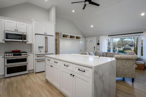a kitchen with white cabinets and a white counter top at 176 Sudbury Lane Hyannis Cape Cod - - Need Name in Hyannis