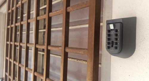 a close up of a door with a remote control at Low Budget SingleBed Bedroom in Kuala Lumpur