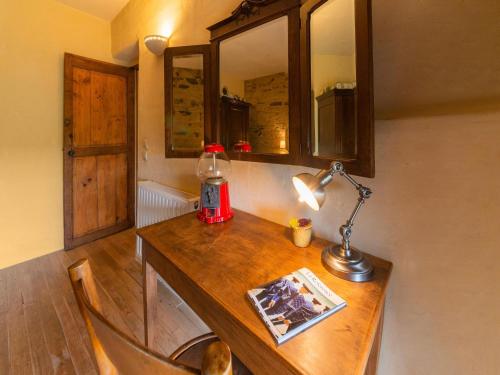 a desk with a lamp and a book on it at Tranquil Home in Tinlot in Tinlot