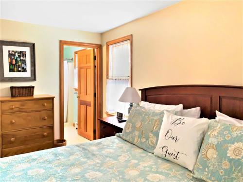 a bedroom with a bed with a wooden head board at 122 Tracy Lane Brewster Cape Cod - Jack's Little Cape House in Brewster