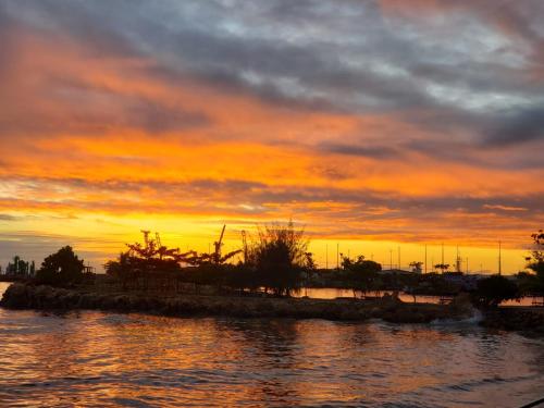 a sunset over a body of water with the sky at Heritage Park Hotel in Honiara