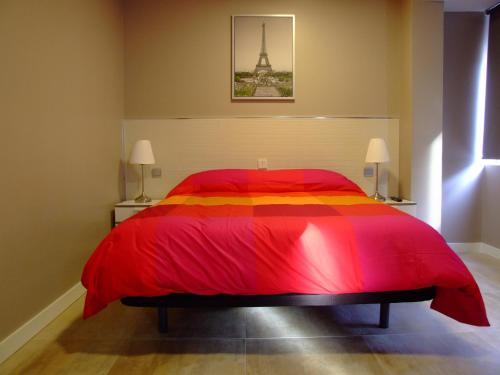 a bedroom with a bed and a dresser at Hostal Vintage Santander in Santander