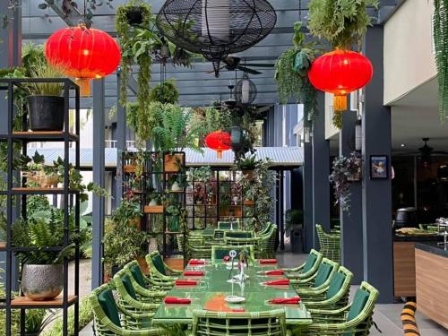 a long table with green chairs and red lanterns at Heritage Park Hotel in Honiara