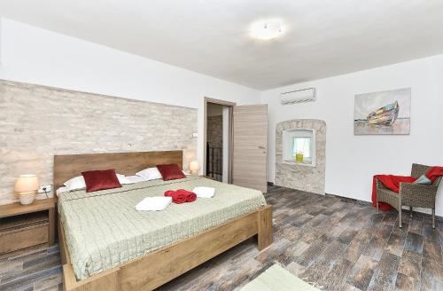 a bedroom with a bed with a red flower on it at Family friendly house with a swimming pool Butkovici, Central Istria - Sredisnja Istra - 20751 in Svetvinčenat