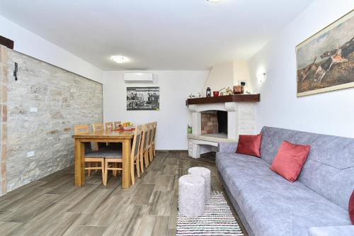 a living room with a couch and a table at Family friendly house with a swimming pool Butkovici, Central Istria - Sredisnja Istra - 20751 in Svetvinčenat