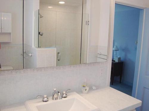 a bathroom with a sink and a large mirror at Waterfront in North Chatham -- Cape Cod in Chatham