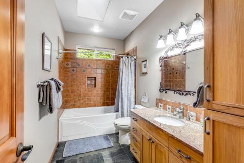 a bathroom with a tub and a toilet and a sink at Cain Lake Lodge in Sedro-Woolley