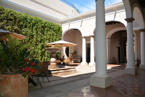 a courtyard with a fountain and an umbrella at Casa Angeles Mascota in Mascota