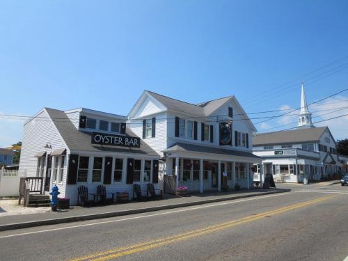 a street scene of a town with a church at 557 Route 28, Unit 203, Harwich Port Cape Cod - - Perfect Rx in Harwich Port