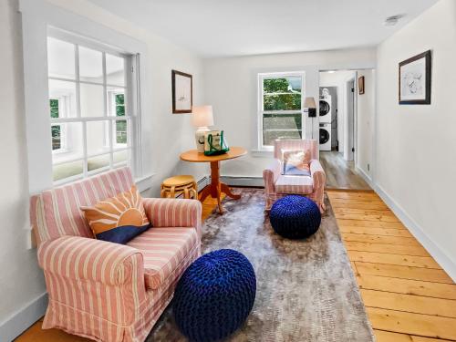 a living room with two chairs and a table at 379 Oak Street Harwich Cape Cod - - Harwich Hideaway in Harwich