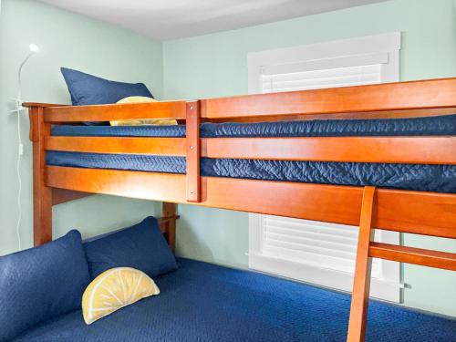 two bunk beds in a room with a couch at 379 Oak Street Harwich Cape Cod - - Harwich Hideaway in Harwich