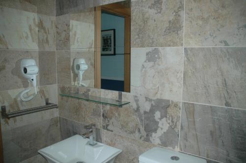 a bathroom with a sink and a mirror at Hostal Vintage Santander in Santander